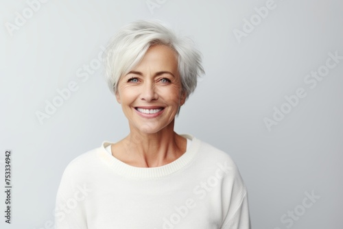 beauty, people and health concept - smiling senior woman over grey background