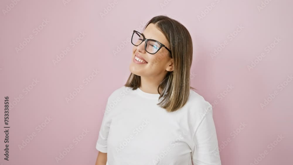 Gorgeous young hispanic woman sporting glasses confidently poses relaxed side profile over pink isolated backdrop, naturally looking off with a cheerful smile. Gorgeous young hispanic woman sporting glasses confidently poses relaxed side profile over pink isolated backdrop, naturally looking off with a cheerful smile.