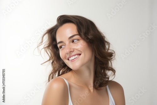 Beauty portrait of young happy smiling woman with long curly hair.