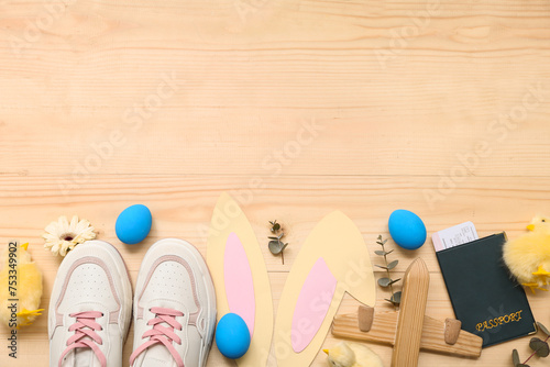 Photography Shoes with toy plane, passport and Easter decor on light wooden background