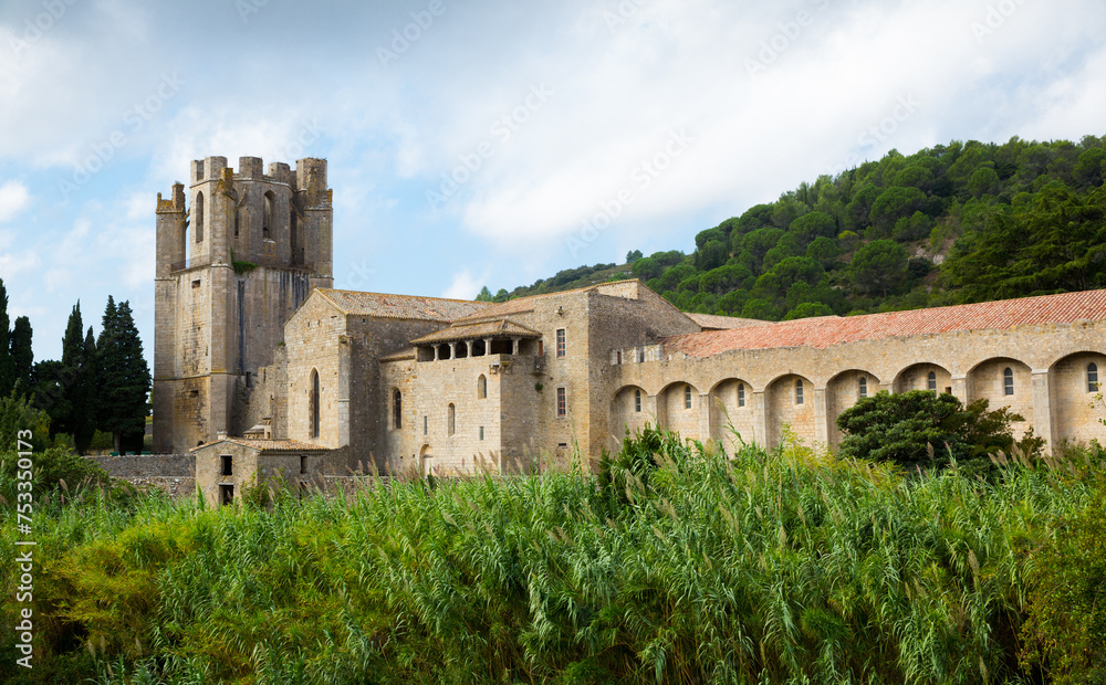 View of Romanesque Benedictine Abbey Sainte-Marie d'Orbieu with bell tower in commune of Lagrasse, France