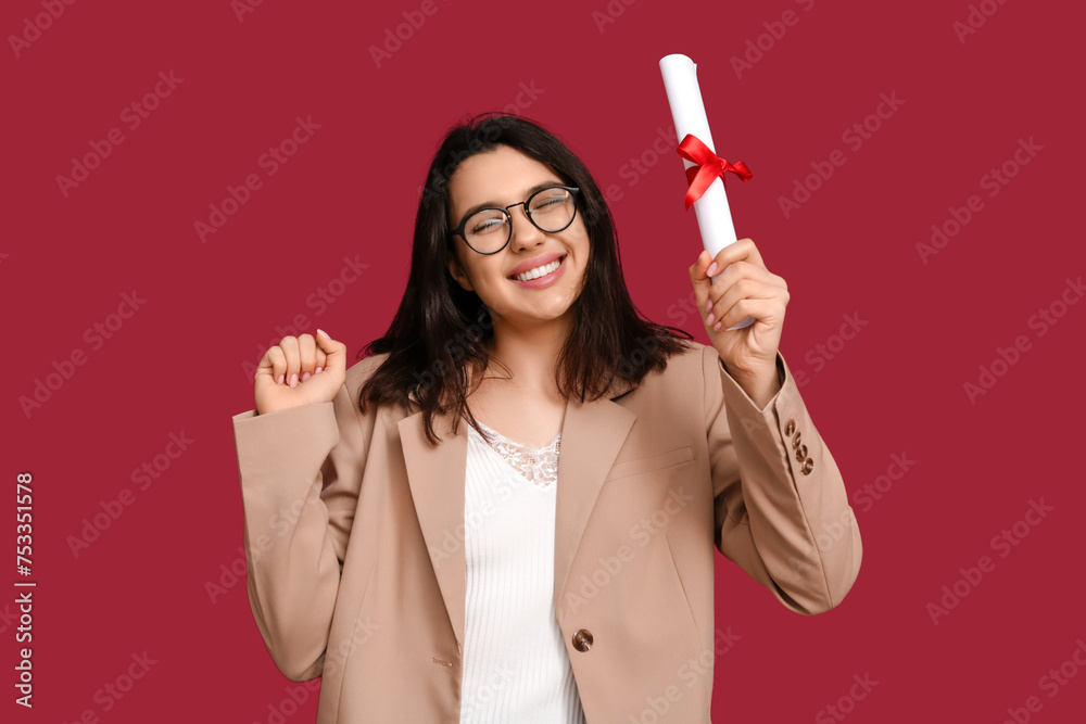 Happy smiling female student with diploma on red background Happy smiling female student with diploma on red background