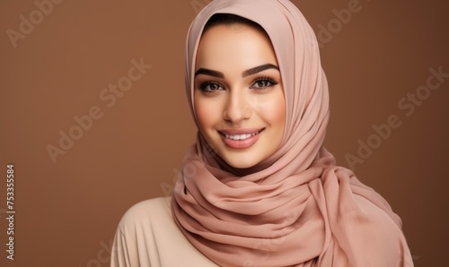 Close-up of a graceful woman in a hijab, featuring warm eyes and a soft smile, set against a blurred urban background