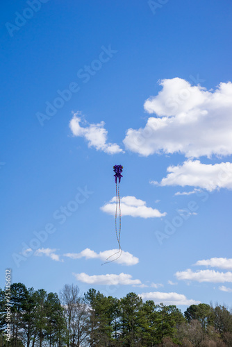 Background of a kite flying on the sky. Flying a kite is common outdoor activity during summer. Kids, adults or family member can play this sport together thanks to mild wind. Nice concept for hobby