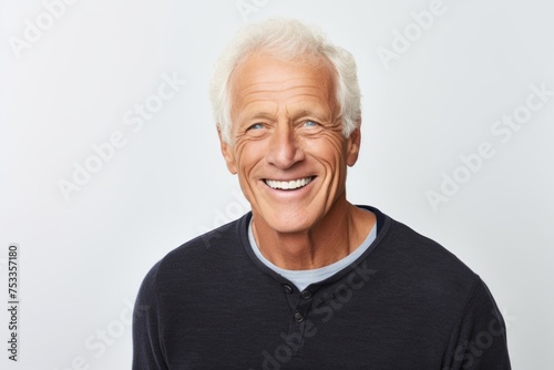 Portrait of a happy senior man. Isolated on grey background.