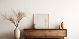 Cozy minimalist living room decor with wooden sideboard, dried flower vase, modern sculpture, books, and personal accessories.