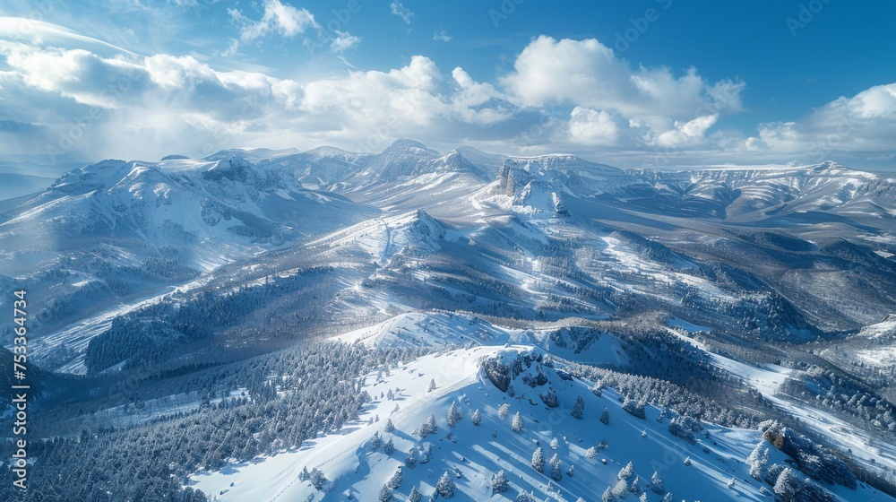 aerial shot  of a mountain range blanketed in snow