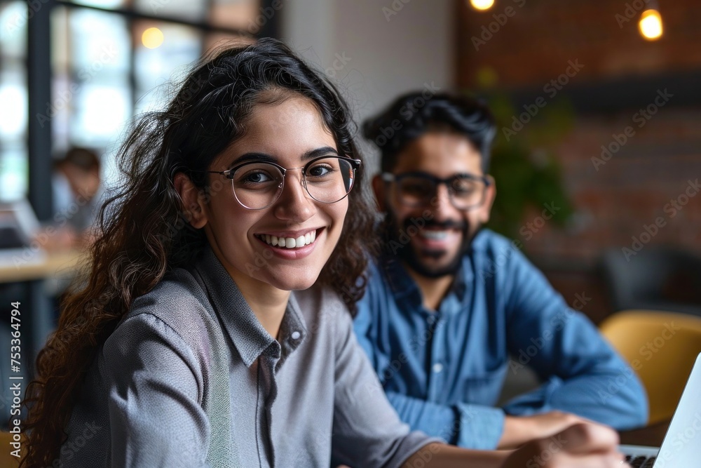 Two professionals - happy smiling indian hr manager and latin young female colleague at office meeting having fun. Mentoring Hispanic male teacher and, Generative AI