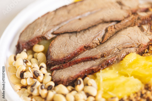 Comida brasileira. Carne de sol acompanhada de mandioca cozida, feijão, paçoca de carne e arroz no fundo. photo