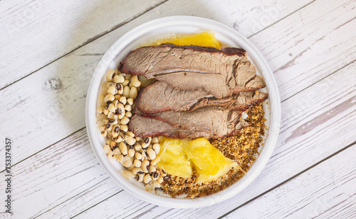 Comida brasileira. Carne de sol acompanhada de mandioca cozida, feijão, paçoca de carne e arroz no fundo. photo