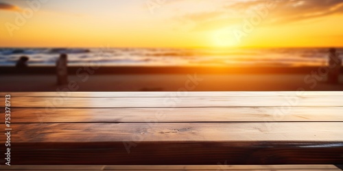 Blurry sunset behind empty wooden table top. Summer evening banner with copy space. In-focus empty bar counter. © Lasvu
