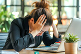 Woman working in office, young business woman stressed or tired from work overload with lots of files on desk
