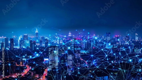A modern city illuminated at night, featuring wireless network connections and connectivity technology