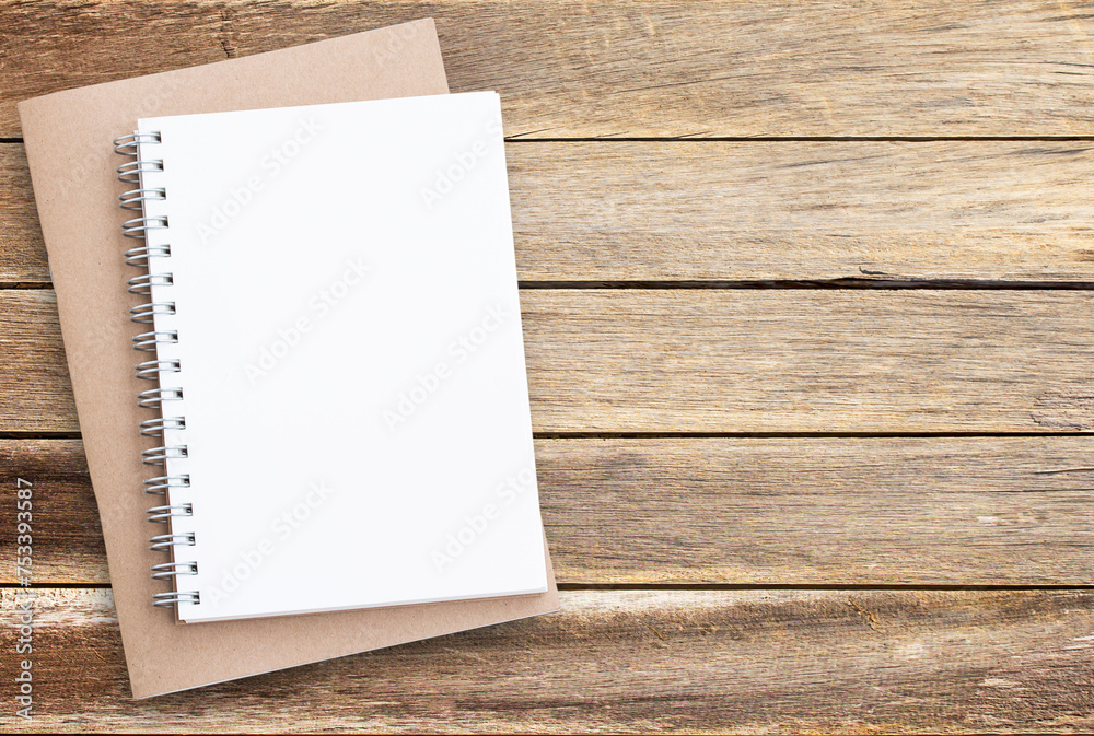 Blank paper notebook on brown wooden table background. Blank paper notebook on brown wooden table background.