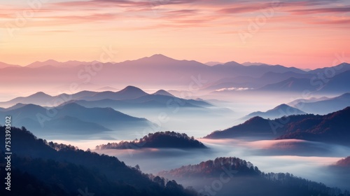 Misty mountain range, sunrise hues © Anuwat
