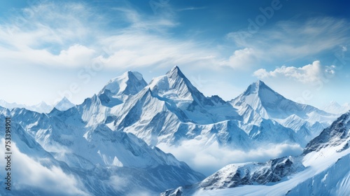 Snow-covered mountain peaks, clear blue sky © FoxGrafy