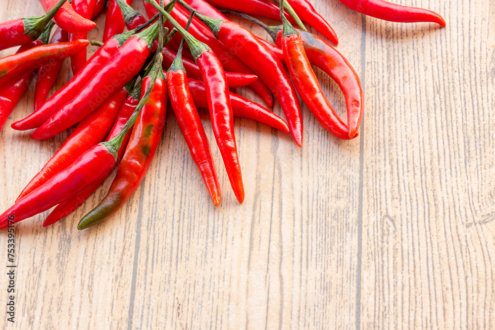 Red hot chili peppers on old wooden table with copy space Red hot chili peppers on old wooden table with copy space