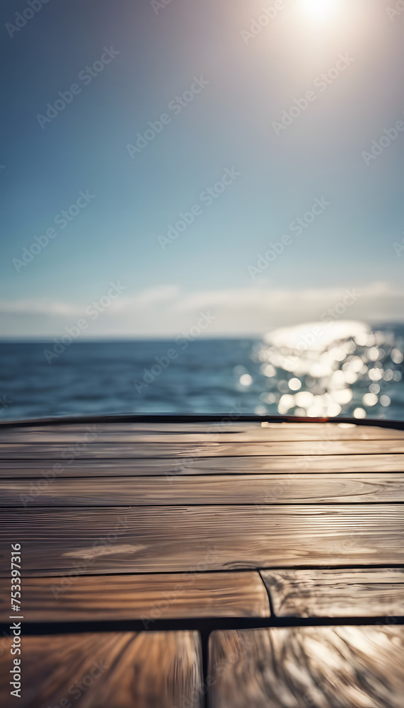 Wooden deck overlooking a calm sea with sunlight reflecting on water, concept of travel and relaxation.
