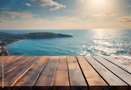 Wooden table top with blurred sea and coastline background, ideal for product display. © Tetlak