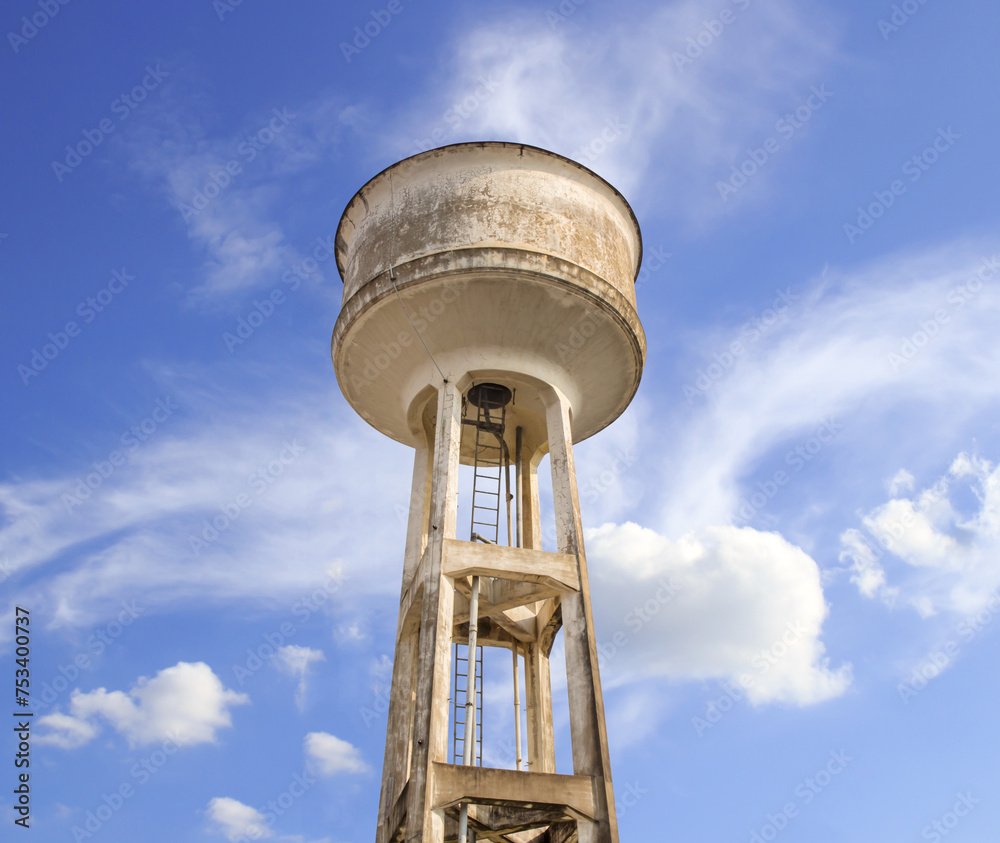 Water tower painted white under blue sky Water tower painted white under blue sky