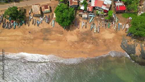 Aerial view from Melão beach and village with the anchored boats at sand, São Tome,Africa photo