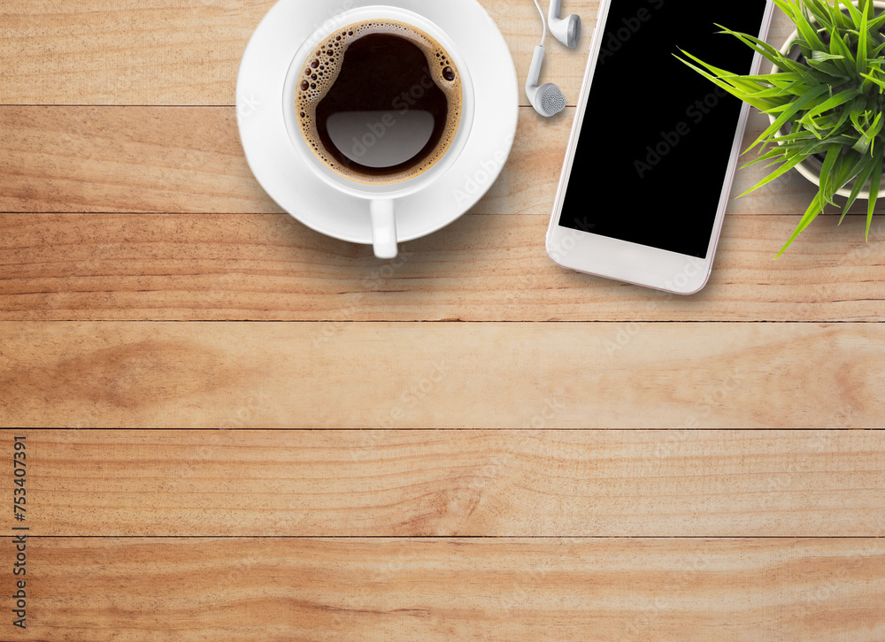 Smart phone and earphone with cup of coffee on old wooden background Smart phone and earphone with cup of coffee on old wooden background