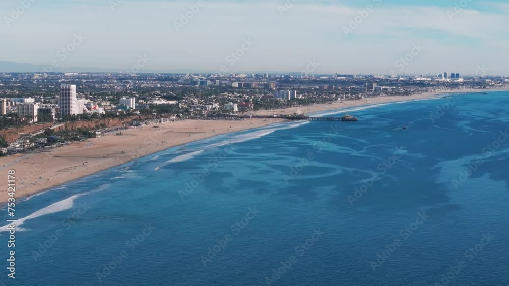 Drone shot panning to the right overlooking the santa monica beach and pier Drone shot panning to the right overlooking the santa monica beach and pier