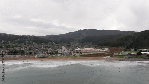 pullback drone shot revealing a surf spot on the beach of pacifica, california photo