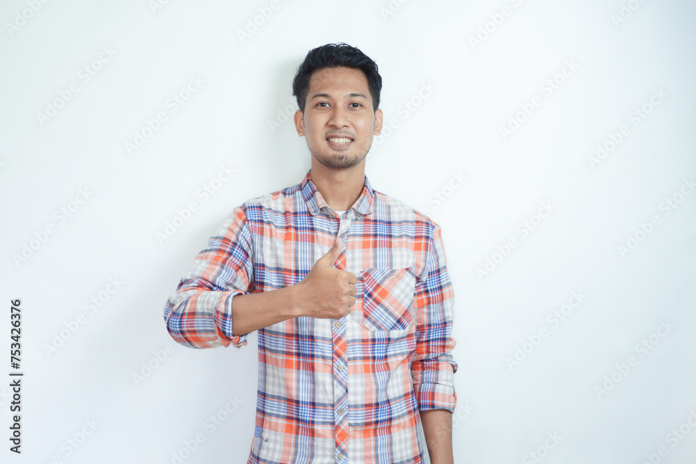 Fototapeta premium Adult Asian man smiling and give thumb up at camera