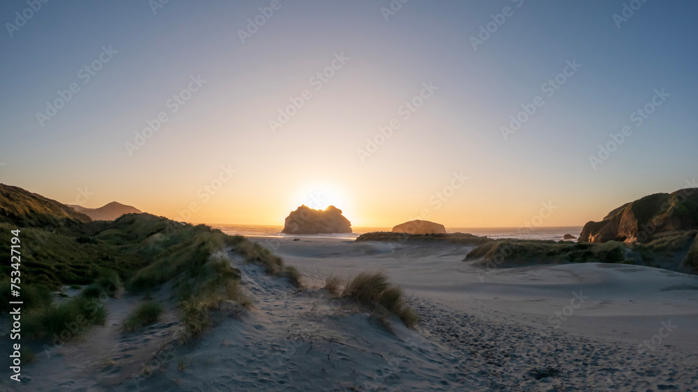 Golden Hour Serenity: Sunset Landscape Overlooking Wharariki Beach and the Tasman Sea, South Island, New Zealand