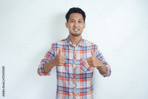Adult Asian man showing cheerful expression and give two thumbs up photo