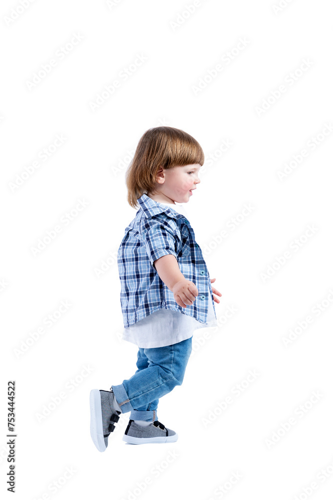 Smiling little boy 2 years old runs. Child wearing a blue checkered shirt and a white T-shirt. Activity, energy and childlike spontaneity. Full height. Side view. Isolated on a white background. Smiling little boy 2 years old runs. Child wearing a blue checkered shirt and a white T-shirt. Activity, energy and childlike spontaneity. Full height. Side view. Isolated on a white background.