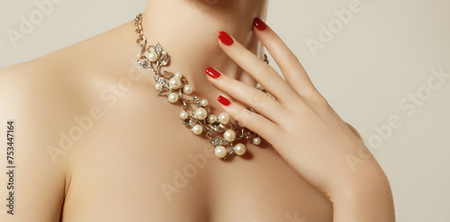 Elegant fashionable woman with jewelry. Beautiful woman with a necklace. Beauty younag model with a pendant on a gray background. Jewellery and accessories