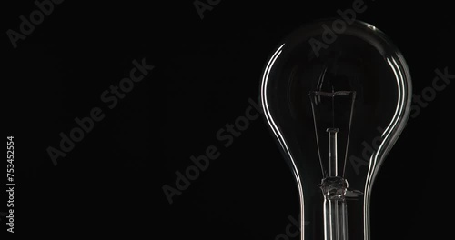 Right-Framed Shot Of Clear Light Bulb Dimming To Low Level And Going Off Again