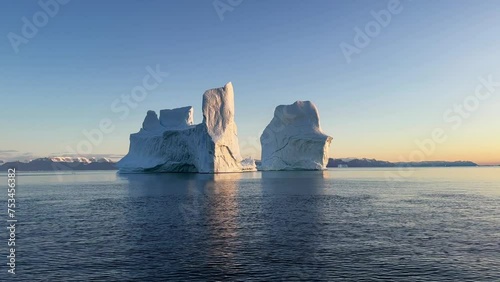 Icebergs in Hall Bredning Fjord after sunset in Scoresbysund, Greenland. photo