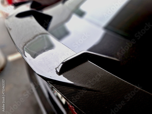 the carbon pressure wing of the car helps load the rear axle of the wheels to the road. sports homologated original modifications of cars. exhaust tip. photo