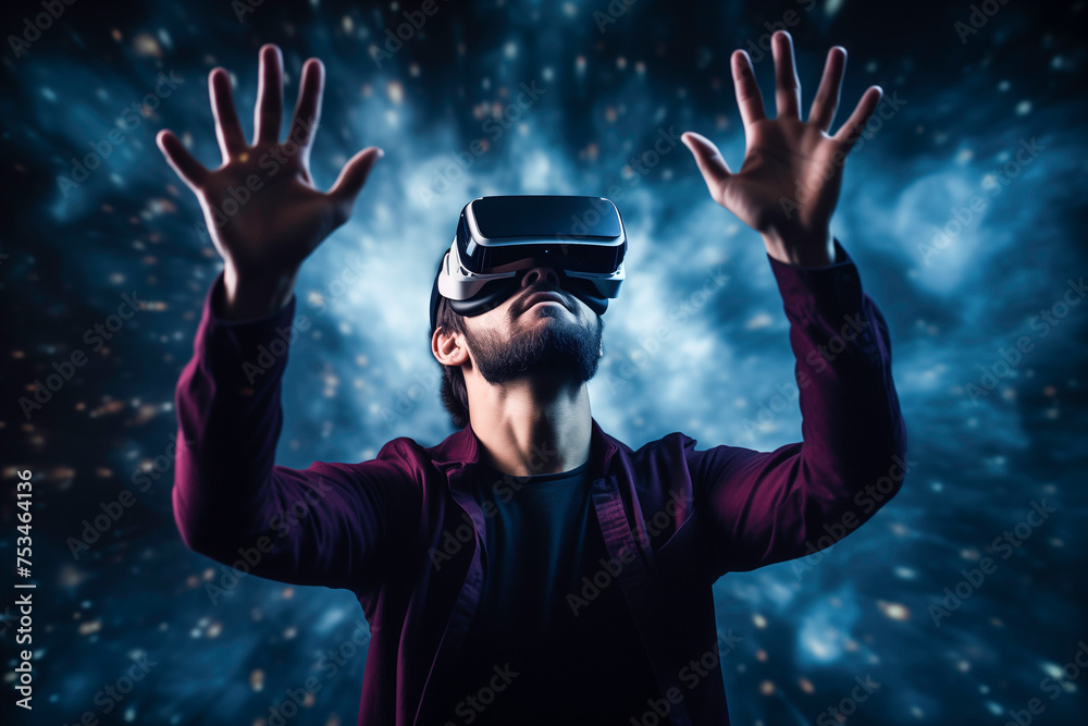 Handsome man in virtual reality glasses touches the air with his hand on a black background Handsome man in virtual reality glasses touches the air with his hand on a black background