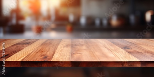 Blurred kitchen background with a wooden table top. © Lasvu