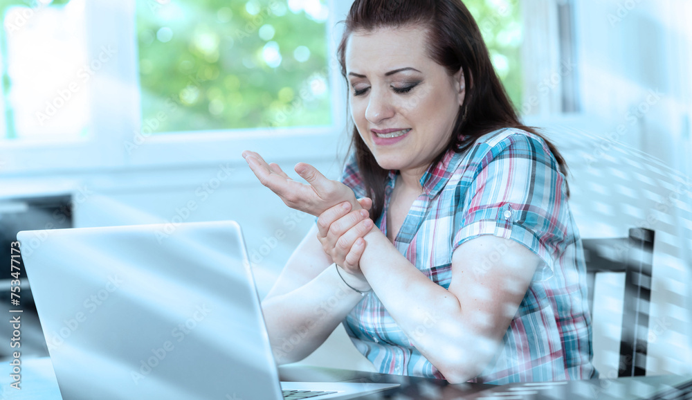Businesswoman suffering from wrist pain; light effect Businesswoman suffering from wrist pain; light effect