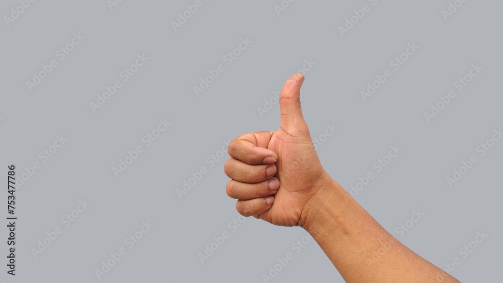 thumb up hand gesture, gray background