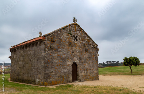 Romanesque hermitage of Nuestra Señora de La Lanzada from the beginning of the 13th century. Noalla, Galicia, Spain. photo