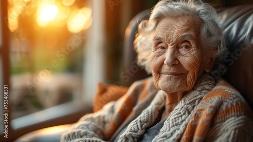 An elderly woman sitting in a chair wearing a cozy sweater