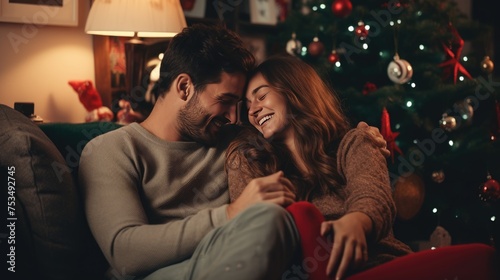 A Couple Cuddling and Smiling During Christmas Time