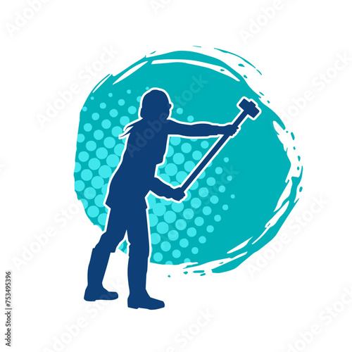 Silhouette of a worker in action pose using his sledge hammer tool.