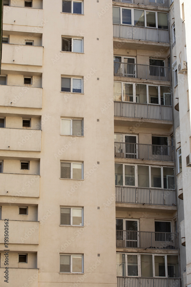 Apartment building, back view with small balconies, typical socialist block of flats in south eastern Europe, vertical shot Apartment building, back view with small balconies, typical socialist block of flats in south eastern Europe, vertical shot