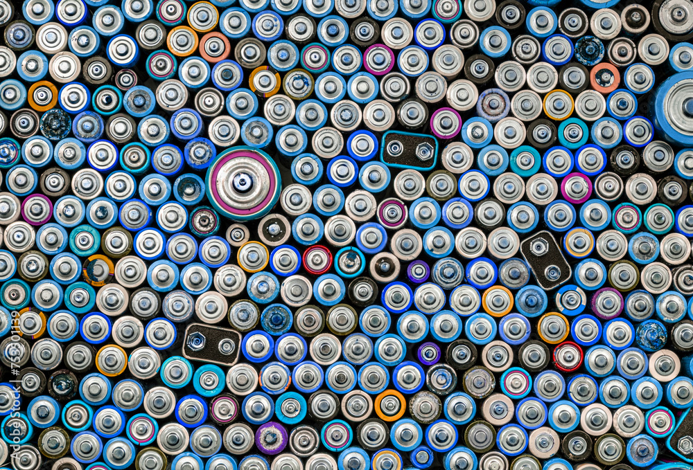 Used batteries from different manufacturers, waste, collection and recycling, high danger for the environment. Batteries background top view Used batteries from different manufacturers, waste, collection and recycling, high danger for the environment. Batteries background top view
