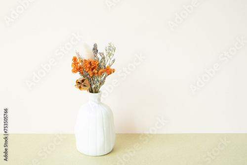 White vase of dry flower on table. white ivory background photo