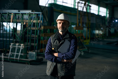 Middle-aged man stands in a production workshop © Viacheslav Yakobchuk