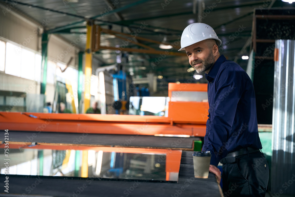Man at a workplace in window production Man at a workplace in window production