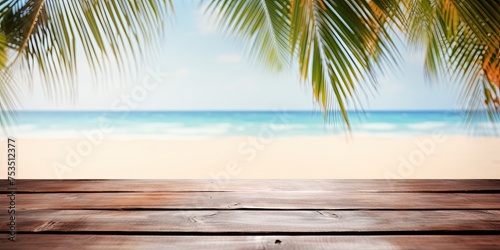 Summer beach background with empty wood table and palm leaves  perfect for product display.